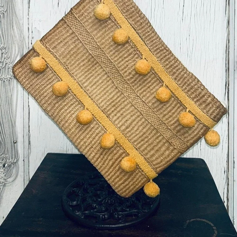 Yellow pom pom raffia clutch bag